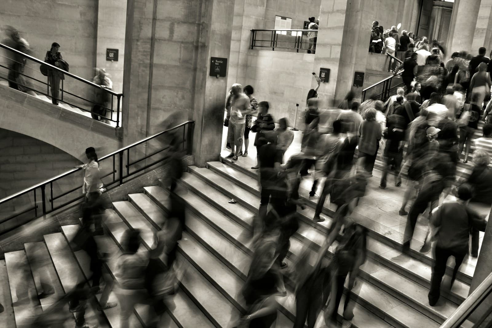 Group of people walking up stairs in a business setting