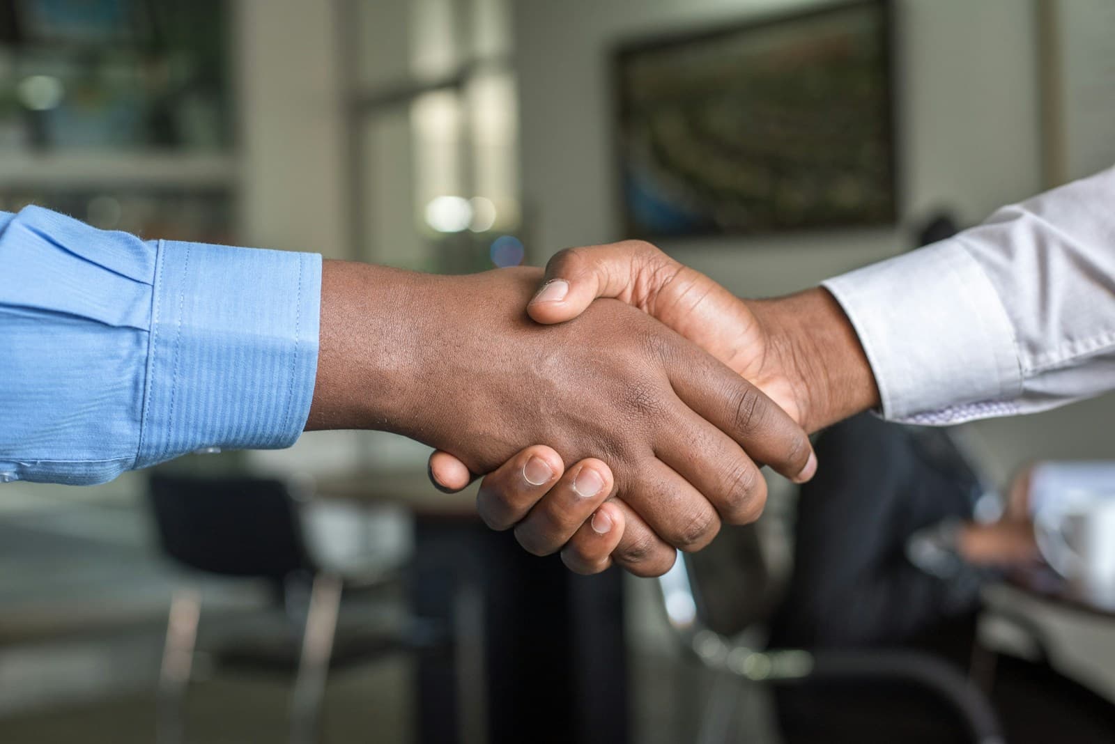 Two people shaking hands in a business setting