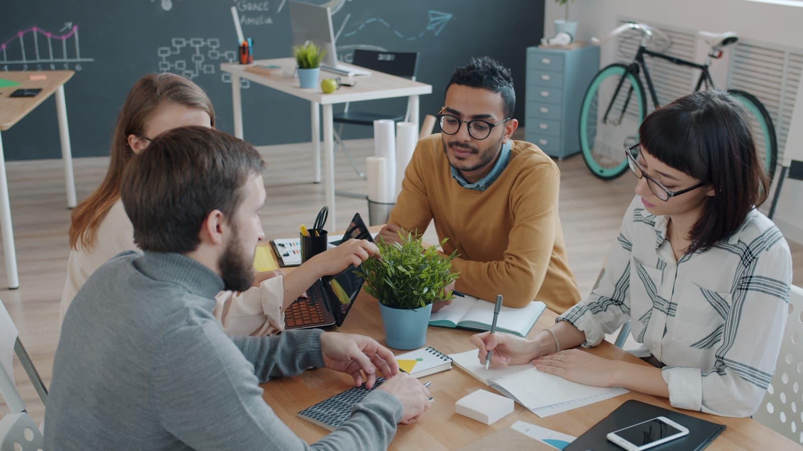 Diverse team collaborating around a table in an office